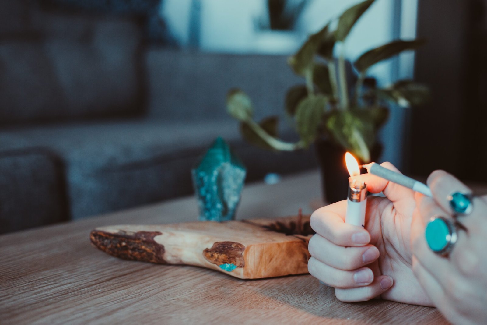 person holding lighted candle on brown wooden chopping board